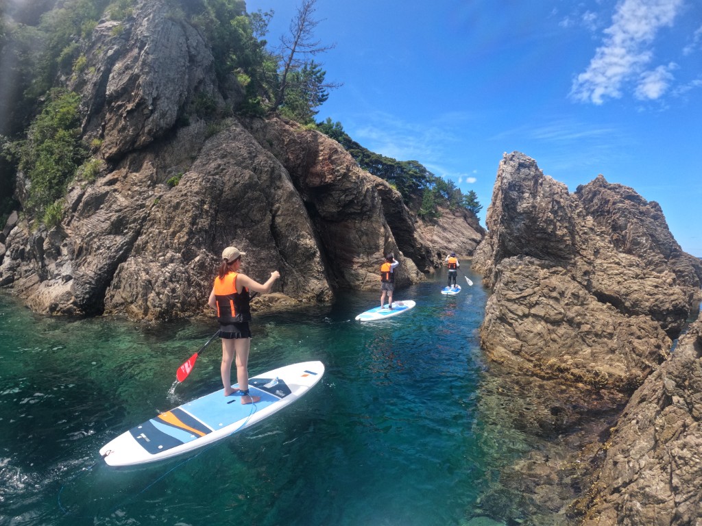 Paddling SUP through a sea cave