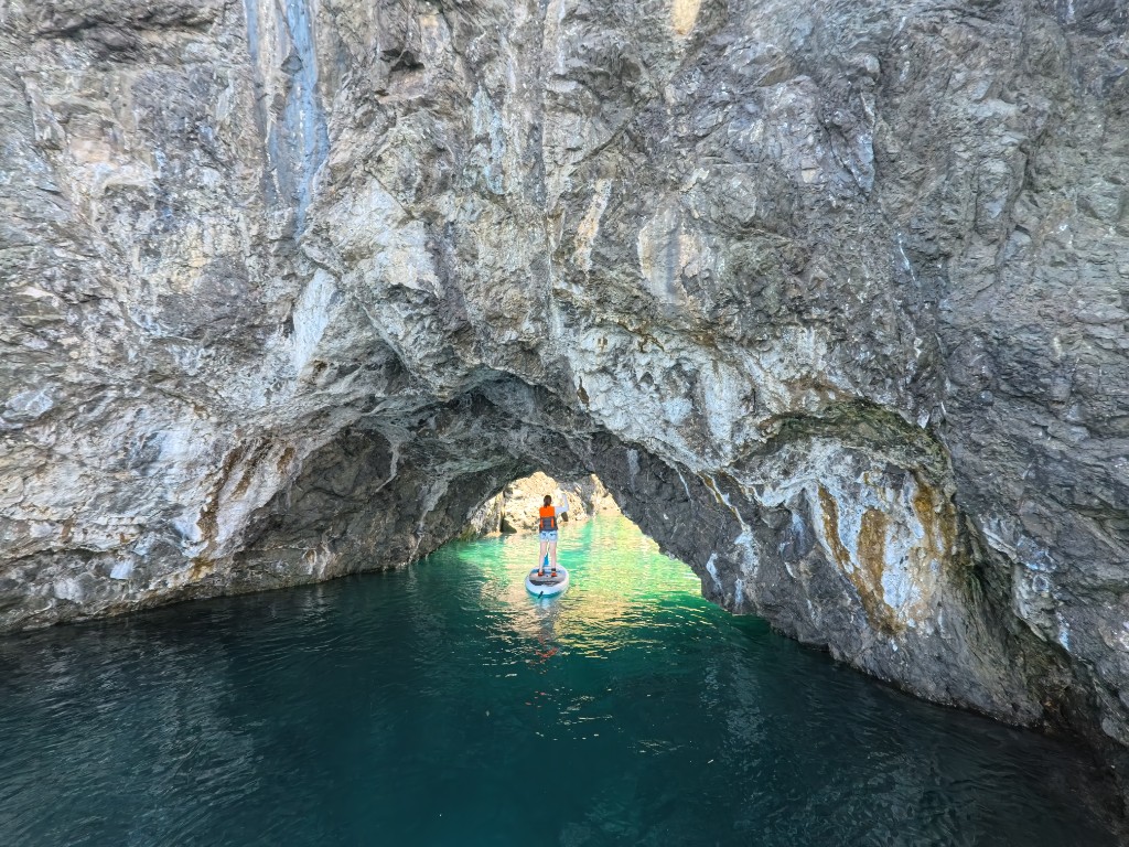 Paddling SUP through a rocky channel