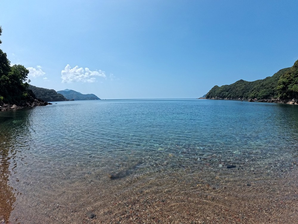 Clear shallow water in a cove of Wakasa Bay, with headlands on both sides